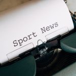 Close-up of a vintage typewriter with 'Sport News' typed on paper, evoking retro charm. — 7bit Casino : Comment tirer profit