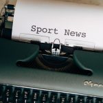 Close-up of a vintage typewriter with a paper showing 'Sport News', evoking nostalgia and classic journalism. — Die Softwarea