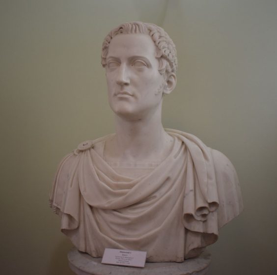 Close-up of a classical Roman statue bust displayed in a museum exhibit. — Julius Caesar The Man Who Changed Rome Forever
