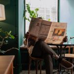 A man sits in a cozy café corner, enjoying a newspaper and relaxed ambiance. — KokoBet Casino: Quick Spin, Fast Wins & Instan